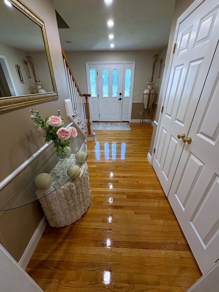 Polished hardwood entryway with a mirror-like shine
